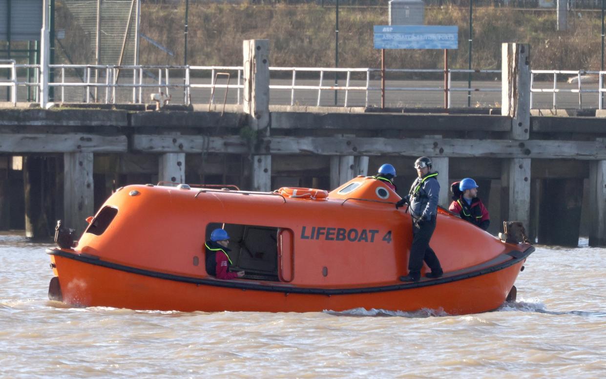 A lifeboat sweeps the river Wyre multiple times where it meets the estuary of Morecambe Bay, in Lancashire - Julian Hamilton