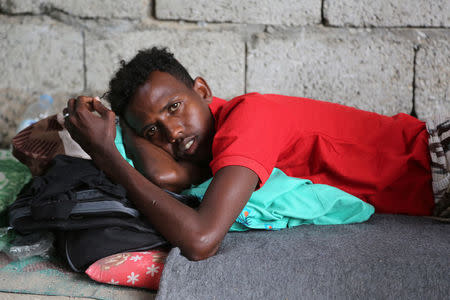 A Somali refugee, who was among survivors of an attack on a boat off Yemen's coast in the Red Sea, lies at a detention center in the Houthi-held port of Hodeidah, Yemen, March 22, 2017. Picture taken March 22. REUTERS/Abduljabbar Zeyad