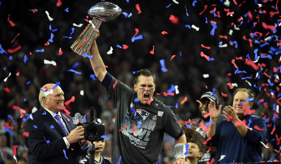 (FILES) In this file photo taken on February 05, 2017, Tom Brady, #12 of the New England Patriots, holds the Vince Lombardi Trophy after defeating the Atlanta Falcons in overtime during Super Bowl 51 at NRG Stadium in Houston, Texas. - Seven-time Super Bowl champion quarterback Tom Brady will retire after 22 NFL seasons, according to multiple US media reports on January 29, 2022. (Photo by Timothy A. CLARY / AFP) (Photo by TIMOTHY A. CLARY/AFP via Getty Images)