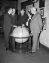 <p>Left to right: Sir George Hubert Wilkins, explorer and writer; Joseph Robinson, secretary of the Explorers’ Club; Walter Granger, president of club; Lady Grace Drummond Hay, writer; and Dr. H. J. Spinden, director of the Brooklyn Museum, study the route of the Zeppelin Hindenburg’s flight to America on a globe at the Explorers’ Club in New York on May 10, 1936. (AP Photo/John Lindsay) </p>