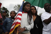 <p>Erika Rigaud,15, holds an American flag as she joins with others to mark the 8th anniversary of the massive earthquake in Haiti and to condemn President Donald Trump’s reported statement about immigrants from Haiti, Africa and El Salvador on Jan. 12, 2018 in Miami, Fla. (Photo: Joe Raedle/Getty Images) </p>