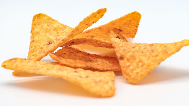 A pile of Doritos chips on a white background