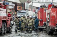 <p>A group of firefighters walk near the scene of the multistory shopping center after a fire in the Siberian city of Kemerovo, about 3,000 kilometers (1,900 miles) east of Moscow, March 26, 2018. Russian officials say a fire at the shopping mall killed over 50 people. The Ekho Mosvky radio station quoted witnesses who said that the fire alarm did not go off and that the staff in the mall in Kemerovo did not organize the evacuation. (AP Photo) </p>