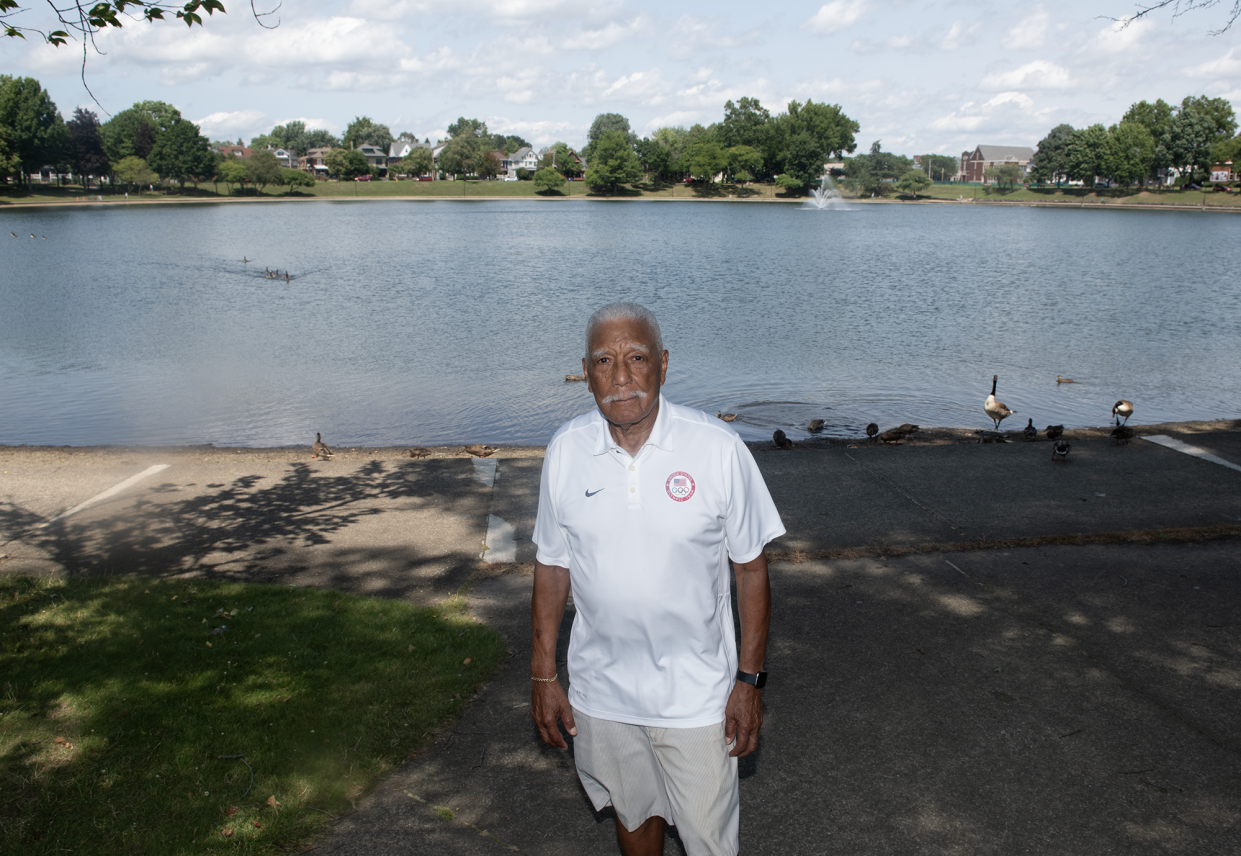 Lester Carney, 90, of Akron, who won a silver medal at the 1960 Olympics in the 200 meters, poses in front of Lake Anna in Barberton.