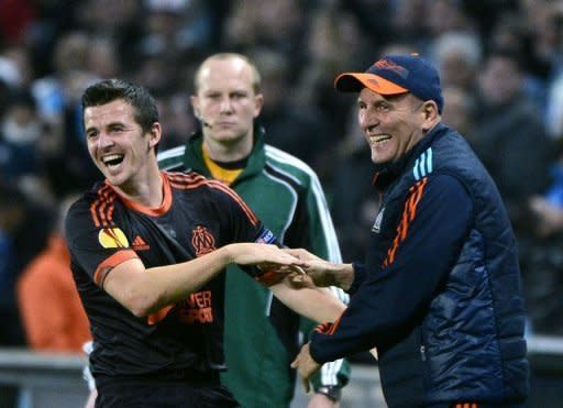 Marseille's Bristish midfielder Joey Barton (L) reacts with Marseille's French head coach Elie Baup (R) after scoring a goal during the UEFA Europa League football match Olympique Marseille vs Borussia Moenchengladbach at the Velodrome stadium in Marseille. The match ended in a 2-2 draw