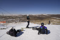 Snowboarders get ready to hit the slope at the Afriski ski resort near Butha-Buthe, Lesotho, Sunday July 31, 2022. While millions across Europe sweat through a summer of record-breaking heat, Afriski in the Maluti Mountains is Africa's only operating ski resort south of the equator. It draws people from neighboring South Africa and further afield by offering a unique experience to go skiing in southern Africa. (AP Photo/Jerome Delay)