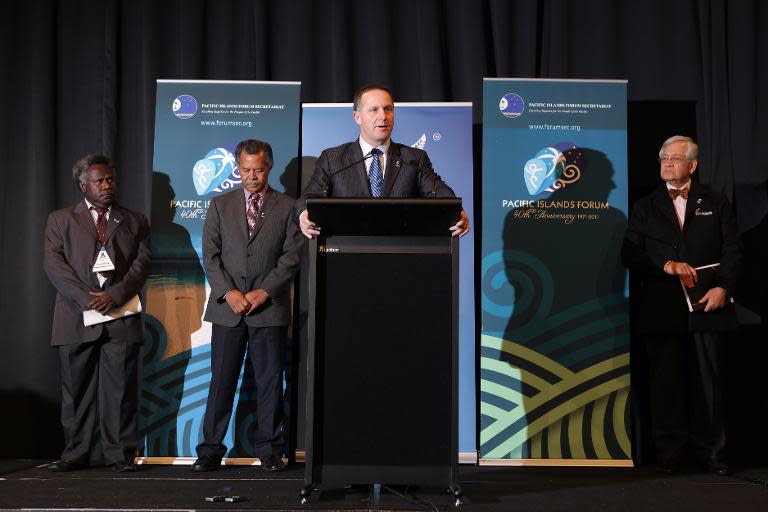 New Zealand's Prime Minister John Key (C) speaks to the press during the annual Pacific Islands Forum (PIF) summit, in Auckland, in 2011