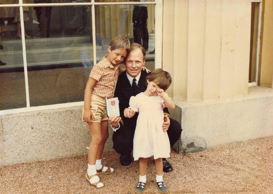 Johnson collecting his MBE at Buckingham Palace, with his children