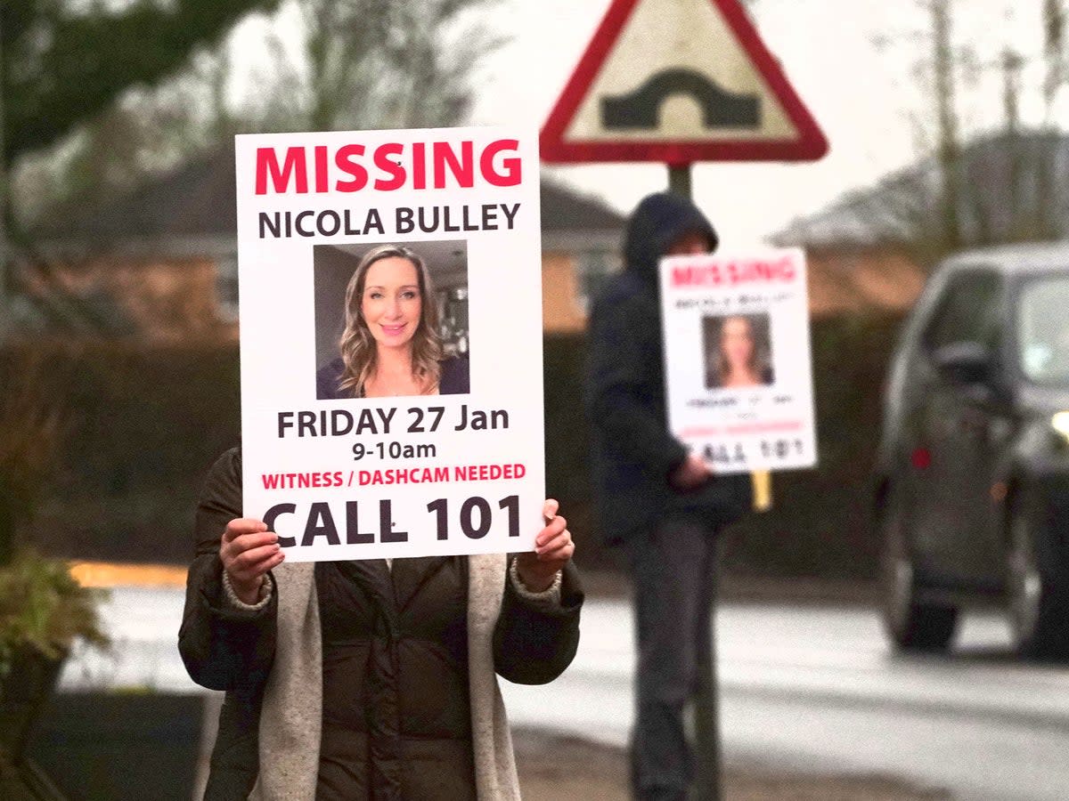 Missing person posters depicting Nicola Bulley are held along a roadside in St Michael’s on Wyre, Lancashire (PA)