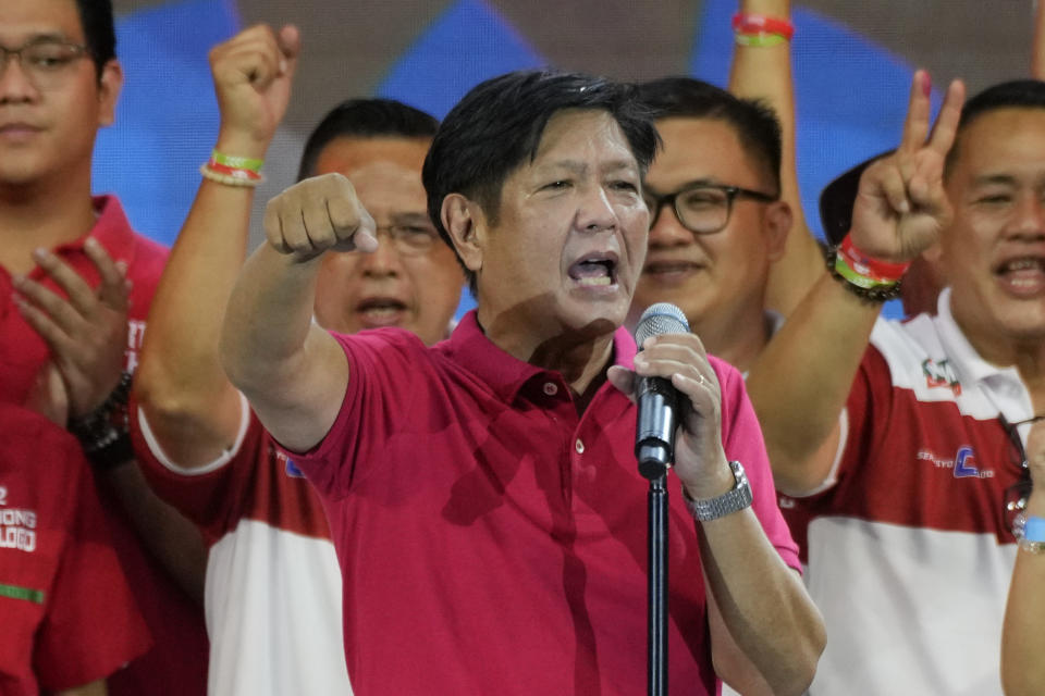 Presidential hopeful, former senator Ferdinand "Bongbong" Marcos Jr., the son of the late dictator, gestures as he greets the crowd during a campaign rally in Quezon City, Philippines on April 13, 2022. The winner of May 9, Monday's vote will inherit a sagging economy, poverty and deep divisions, as well as calls to prosecute outgoing leader Rodrigo Duterte for thousands of deaths as part of a crackdown on illegal drugs. (AP Photo/Aaron Favila)