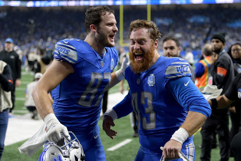 Detroit Lions tight end Sam LaPorta (87) and long snapper Jake McQuaide (43) celebrate after a 2024 NFC wild card game against the Los Angeles Rams at Ford Field.