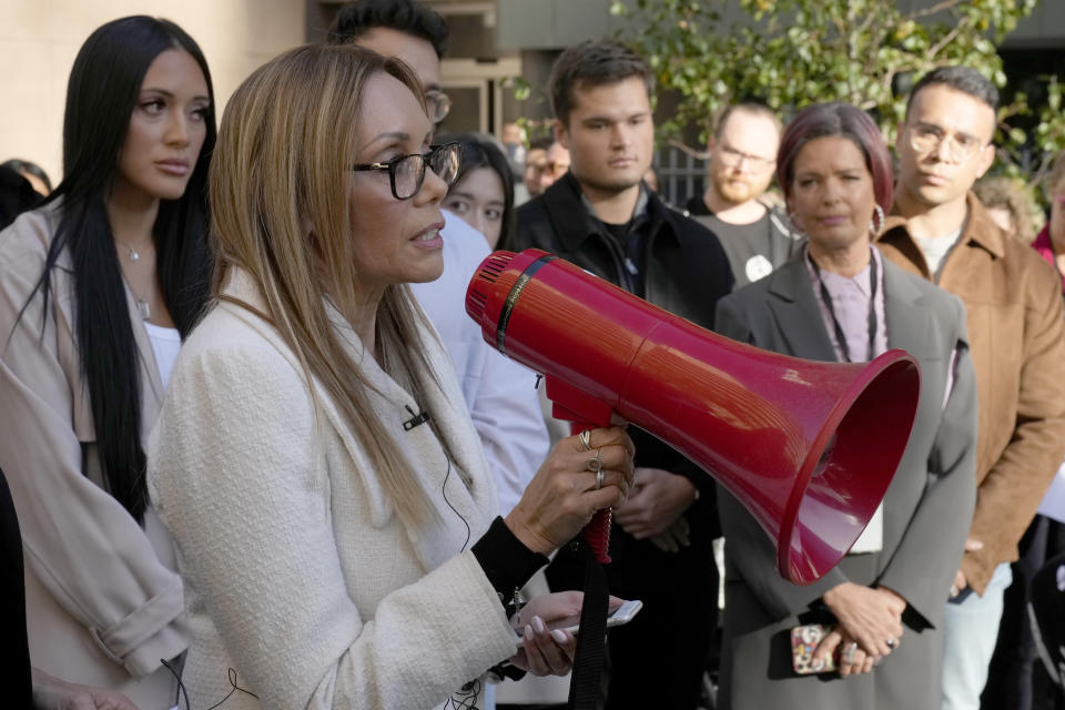 Karla Grant speaks to Australian Broadcasting Corp. (ABC) workers and other supporters as they gather at the ABC offices in Sydney, Monday, May 22, 2023, to support Karla's former husband, Indigenous journalist Stan Grant. Stan Grant announced he would step away from television hosting duties after viewers responded with racist abuse to his comments during King Charles III's coronation about historic Aboriginal dispossession. (AP Photo/Rick Rycroft)