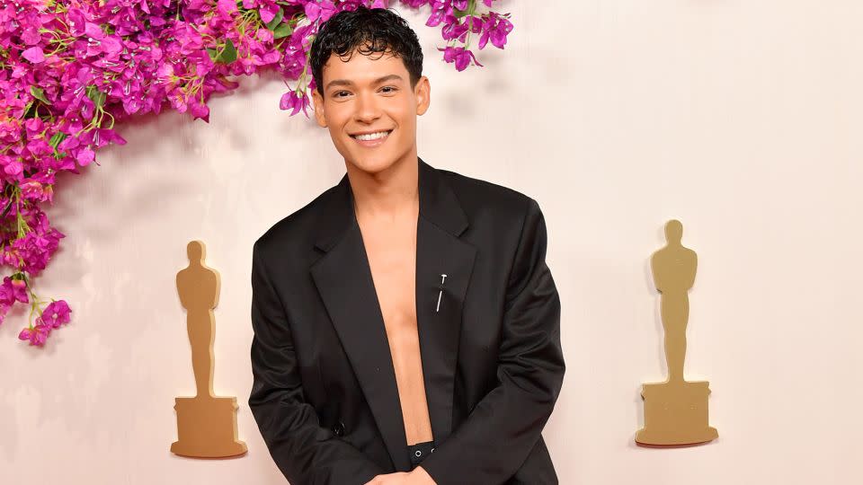 “Young Royals” star Omar Rudberg wore an open double-breasted blazer with a silver brooch pinned to the lapel. - Sarah Morris/WireImage/Getty Images