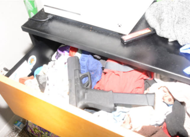 A crime scene photo provided by the U.S. Attorney's Office shows the firearm found in Julius Robinson's bedroom. 