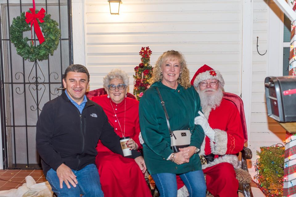 Chris and Connie Lopez pose with Santa and Mrs. Claus during the Another Chance House Home for Christmas event.