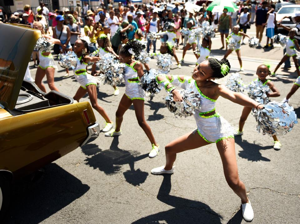 Anaja Campbell (far right) and the Denver Dancing Diamonds preform at 27th in Historic Five Points during the Juneteenth Celebration parade.