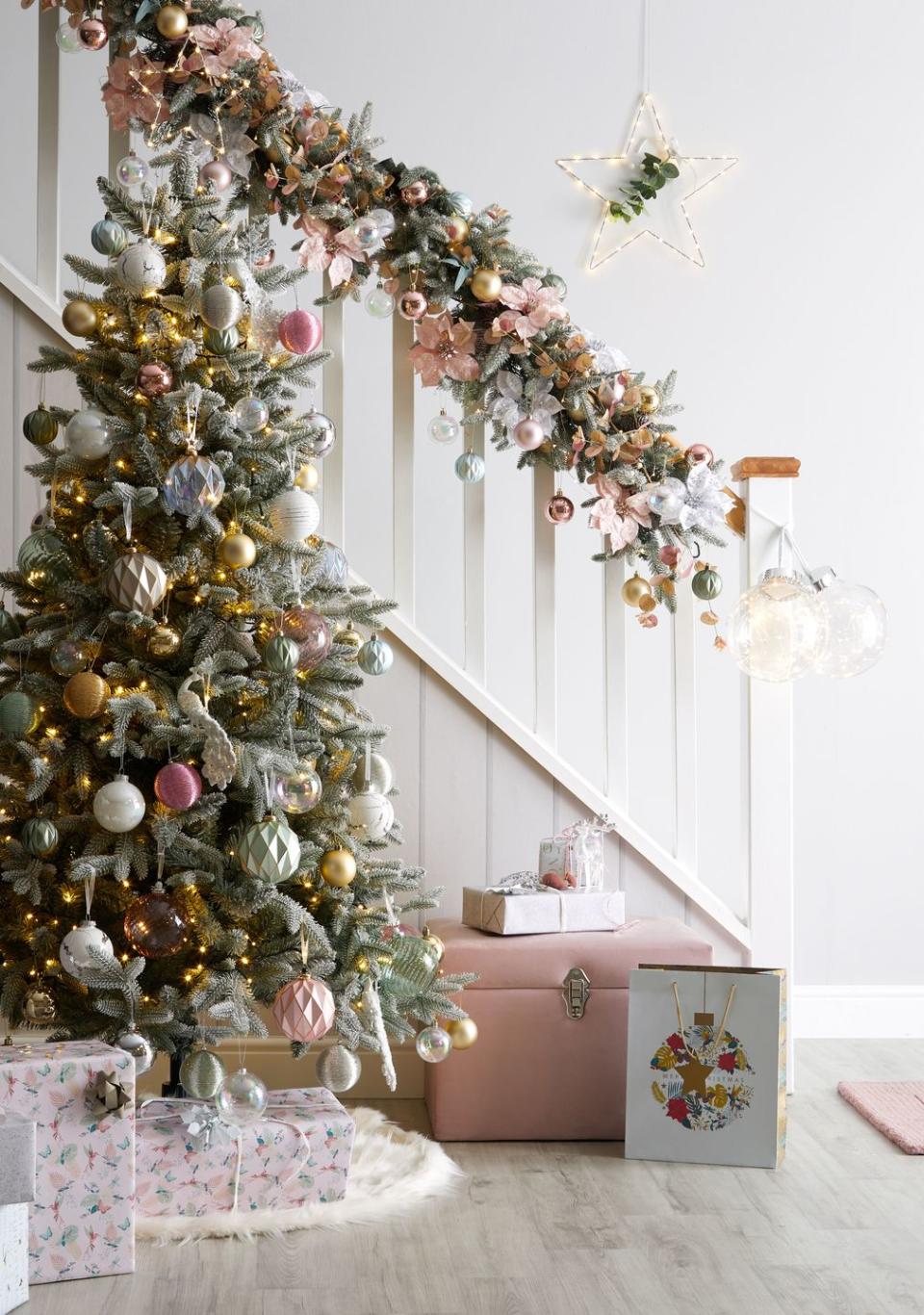 <p>Combine dusky pinks with metallics for Dunelm's Christmas tree trend, Christmas Tropics.</p><p>'A vibrant, tropical twist on Christmas, this glamorous but fun trend blends exotic with traditional,' say Dunelm. 'It mixes fabulous foliage with opulent birds and butterflies.'</p>