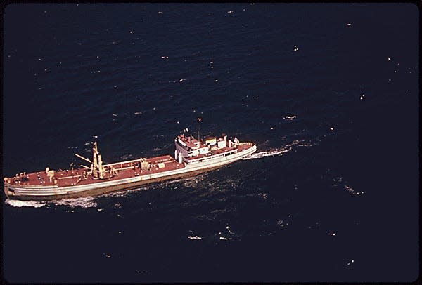 ONE OF FOUR NEW YORK CITY OWNED VESSELS DUMPING SLUDGE INTO WATERS OF THE BIGHT. IN 1973 THERE WERE 5.8 MILLION CUBIC YARDS OF SEWAGE SLUDGE DUMPED IN THE BIGHT. THE VOLUME IS EXPECTED TO TRIPLE IN THE NEXT FEW YEARS. DREDGE SPOILS ARE DUMPED SIX MILES FROM SHORE SLUDGE 12 MILES, WASTE ACID 15 MILES AND CHEMICAL WASTES 106 MILES CONSTRUCTION DEBRIS AND DERELICT VESSELS ALSO ARE DISPOSED OFFSHORE