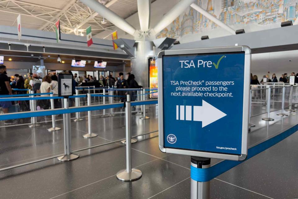 <p>Alessandra Amodio/Travel + Leisure</p> The sign and security lines for TSA PreCheck at JFK airport