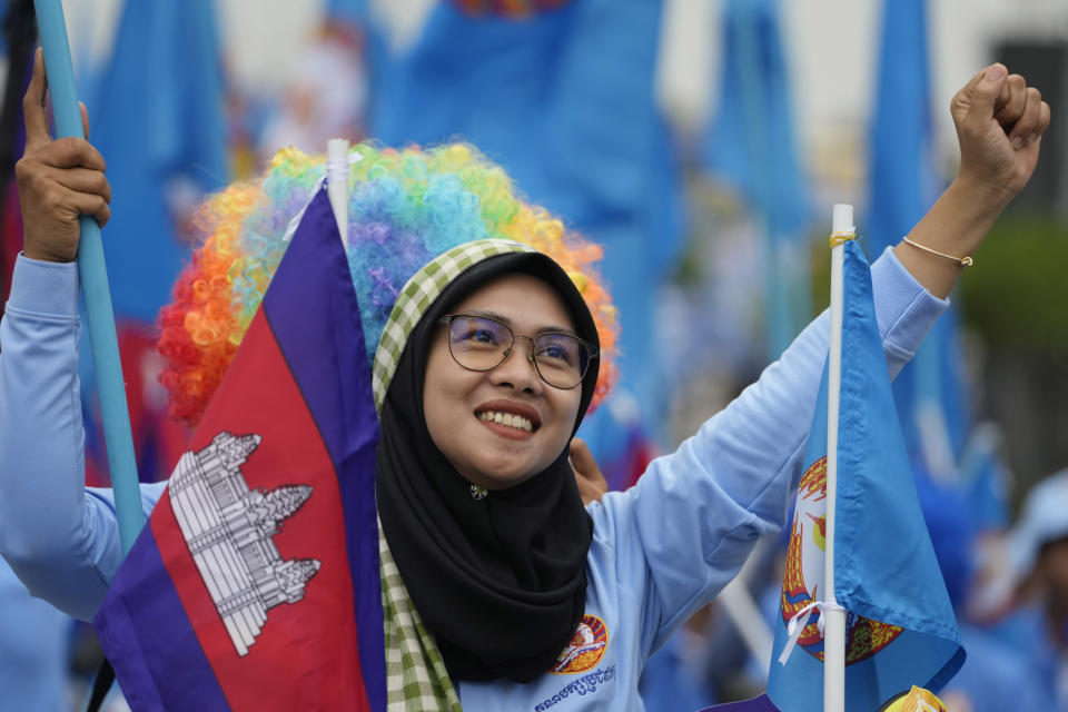 A supporter of the Cambodian People's Party participates in a procession to mark the end of its election campaign in Phnom Penh, Cambodia, Friday, July 21, 2023. The three-week official campaigning period ended Friday for the July 23 general election. Eighteen parties are contesting the polls, but Prime Minister Hun Sen's ruling Cambodian People's Party is virtually guaranteed a landslide victory. (AP Photo/Heng Sinith)