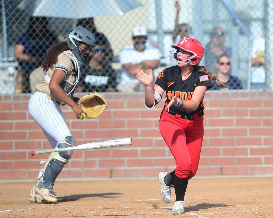 Oakdale’s Raegen Everett (7) celebrates a walk during a game between Oakdale and Central Catholic at Oakdale High School in Oakdale, Calif. on April 17, 2024. Central Catholic won 6-2.