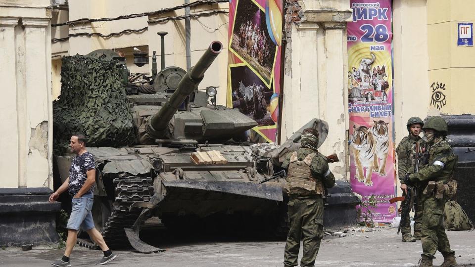 Russian servicemen guard an area standing in front of a tank in a street in Rostov-on-Don, Russia, Saturday, June 24, 2023. In a sign of how seriously the Kremlin took the threat, security was heightened in Moscow, Rostov-on-Don and other regions. (Vasily Deryugin, Kommersant Publishing House via AP)