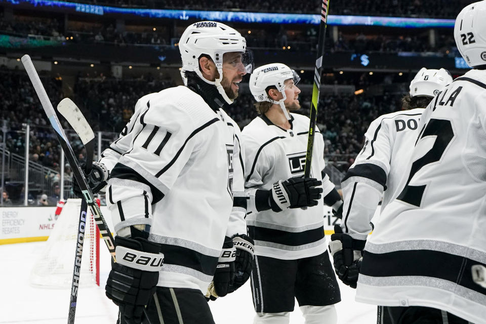 Los Angeles Kings center Anze Kopitar (11) skates back to the bench after celebrating his goal against the Seattle Kraken during the second period of an NHL hockey game Saturday, Dec. 16, 2023, in Seattle. (AP Photo/Lindsey Wasson)