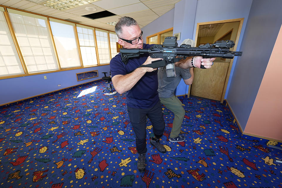 Denver Police Department Sgt. Justin Dodge takes part in a training exercise Friday, June 7, 2024, in a former athletic club now vacant in Lone Tree, Colo. Dodge, a SWAT team supervisor who was providing security along the parade route for the NBA champion Denver Nuggets last June, lost his left leg below the knee when the firetruck carrying guard Jamal Murray and center Nikola Jokic ran over his left ankle. (AP Photo/David Zalubowski)