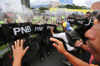 <p>Protesters argue with Bolivarian National Police blocking their path on the Francisco Fajardo Highway in Caracas, Venezuela, June 7, 2016. (AP/Fernando Llano) </p>