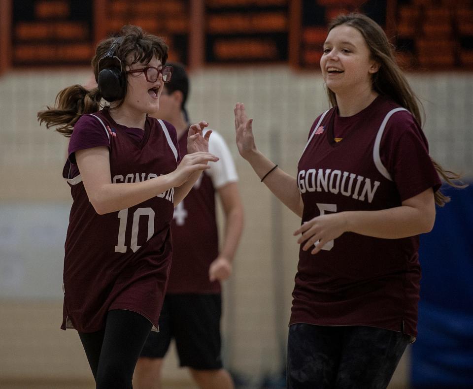 Algonquin Regional High School Titan Cate Campbell, left, high fives Betsy Bertonazzi during a unified basketball game against Marlborough at Marlborough High School, Oct. 26, 2023.