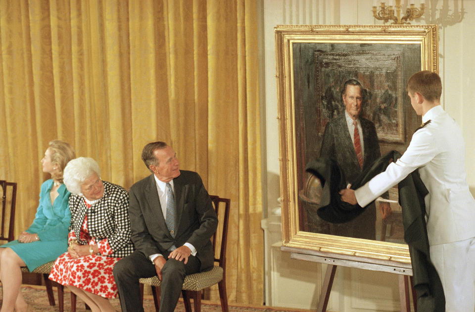 FILE - Former President George H.W. Bush and former first lady Barbara Bush look as his formal portrait is officially unveiled at the Whites House, on Monday, July 17, 1995, in Washington. The Bushes' returned to the White House for the unveiling of both of their portraits which were done by Herbert E. Abrams of Warren, Conn. Former President Barack Obama's presidential portrait will be unveiled at the White House in a Sept. 7, 2022, ceremony hosted by President Joe Biden. (AP Photo/Marcy Nighswander, File)
