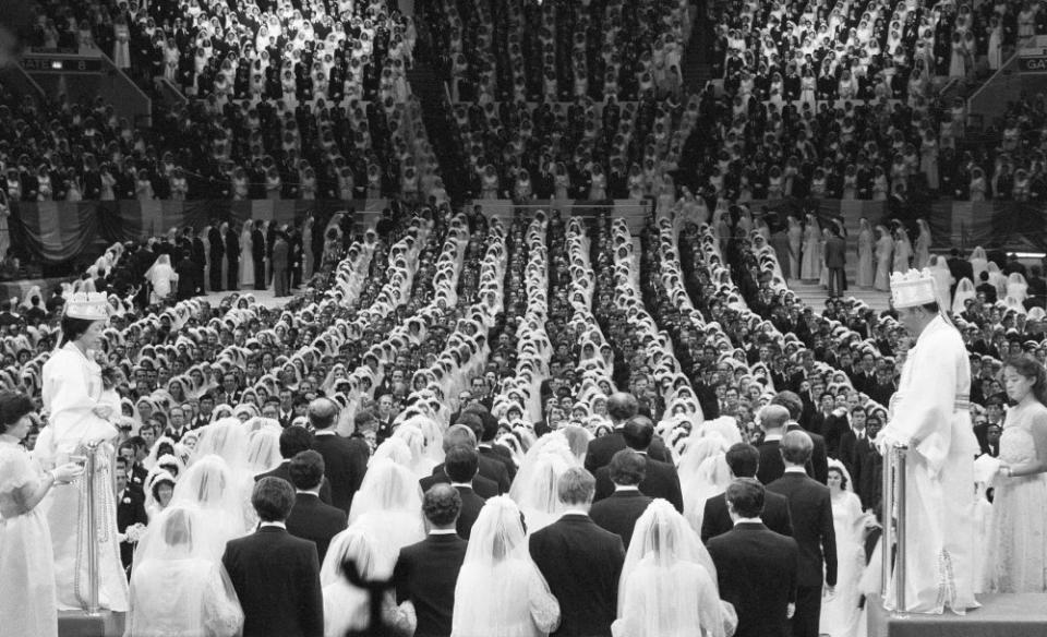 Unification Church leader Rev. Moon and his wife marry 2,075 pairs of his followers at Madison Square Garden on New Years Day, 1982.<span class="copyright">Bettmann Archive/Getty Images</span>