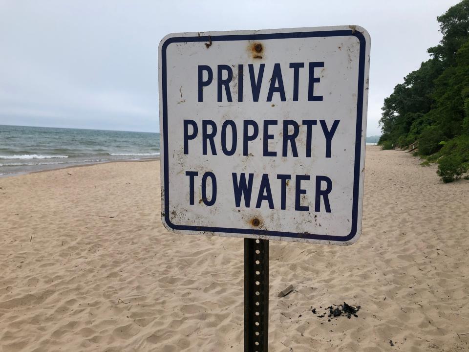 A sign along one of the Chikaming Township beaches warns visitors to stay out of a home owner's property, as seen in 2022