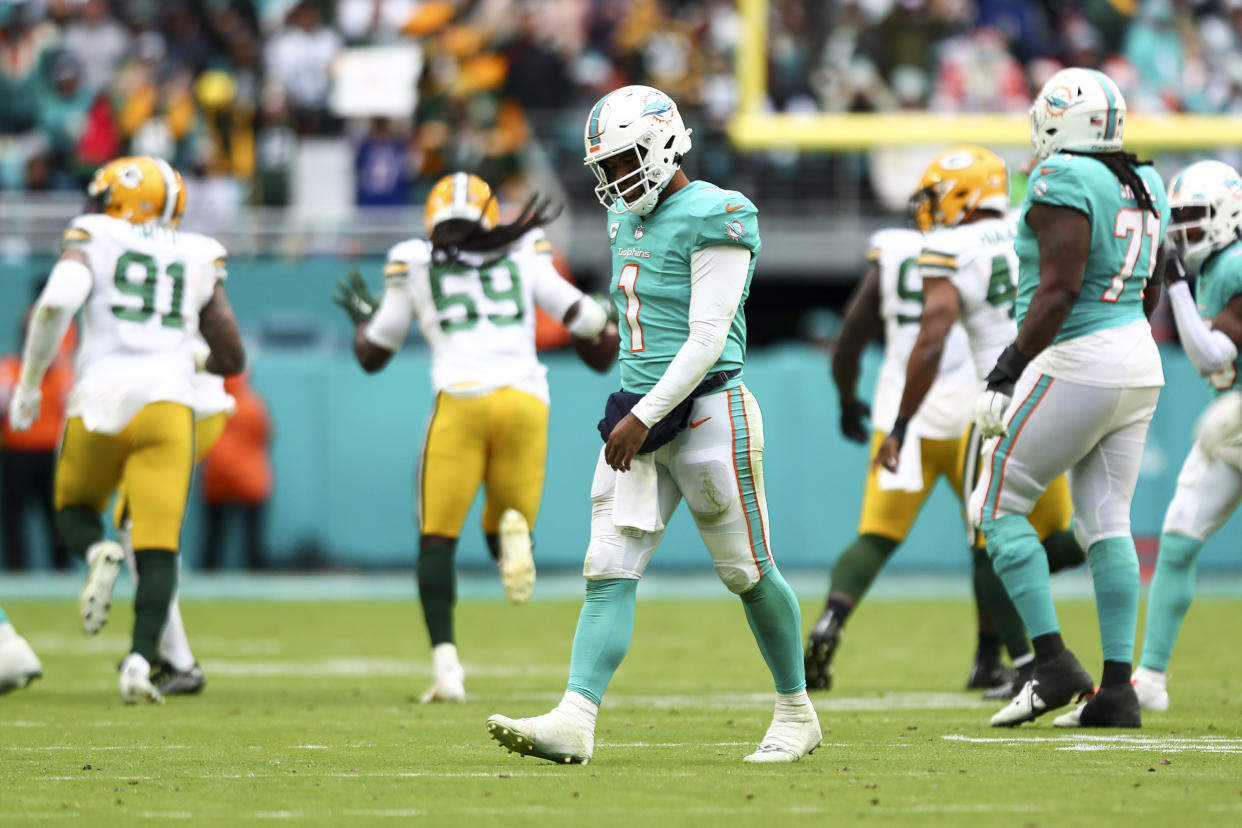 MIAMI GARDENS, FL - DECEMBER 25: Tua Tagovailoa #1 of the Miami Dolphins walks to the sidelines dejected after throwing an interception to De'Vondre Campbell #59 of the Green Bay Packers during the fourth quarter of an NFL football game at Hard Rock Stadium on December 25, 2022 in Miami Gardens, Florida. (Photo by Kevin Sabitus/Getty Images)