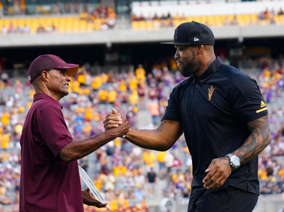 Former ASU football player Terrell Suggs greets AD Ray Anderson (left) as he is announced during the 2022 Hall of Fame induction announcement during halftime at Sun Devil Stadium in Tempe on Oct. 8, 2022.