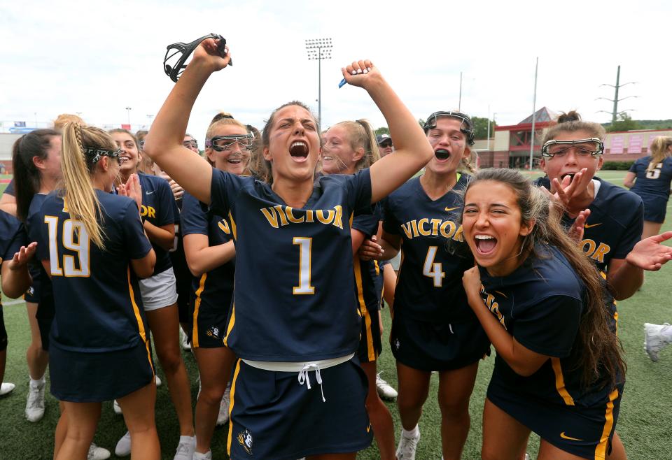 Victor's Eva Prontii (1) and teammates celebrate the Blue Devils 14-5 win over Queensbury to capture the Class B state title.