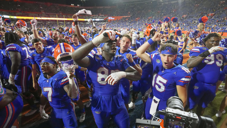 Florida players including Trevor Etienne (7), Caleb Banks (88) and Graham Mertz (15) celebrate after defeating Tennessee in an NCAA college football game, Saturday, Sept. 16, 2023, in Gainesville, Fla. (AP Photo/John Raoux)