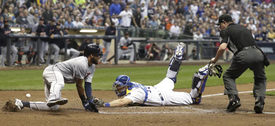 Detroit Tigers' Dawel Lugo scores safely past Milwaukee Brewers catcher Erik Kratz during the sixth inning of a baseball game Saturday, Sept. 29, 2018, in Milwaukee. Lugo scored from third on a sacrifice fly by Pete Kozma. (AP Photo/Morry Gash)