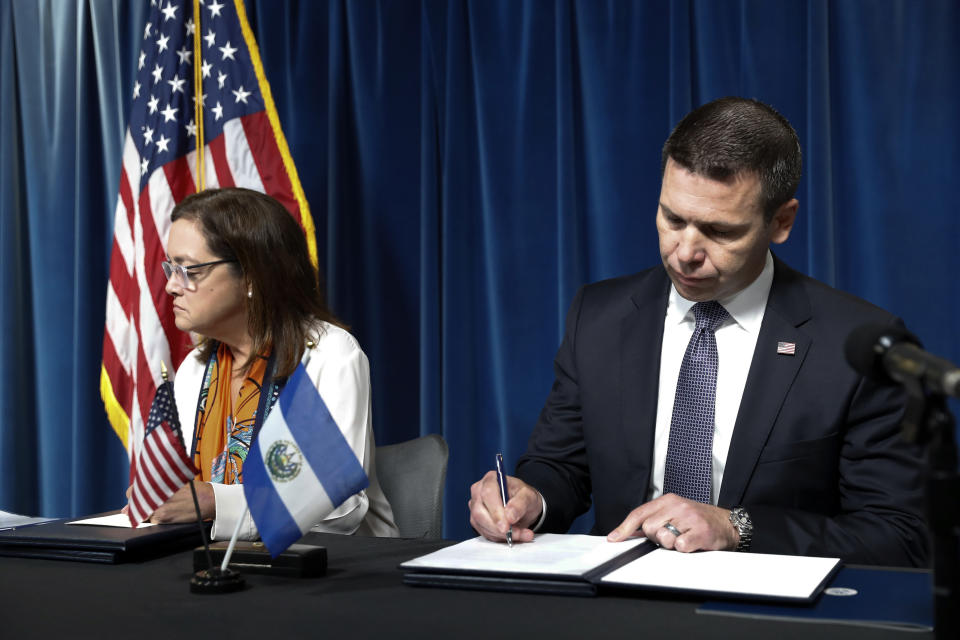 Acting Secretary of Homeland Security Kevin McAleenan signs an agreement with El Salvador Foreign Affairs Minister Alexandra Hill during news conference at the U.S. Customs and Border Protection headquarters in Washington, Friday, Sept. 20, 2019. (AP Photo/Pablo Martinez Monsivais)