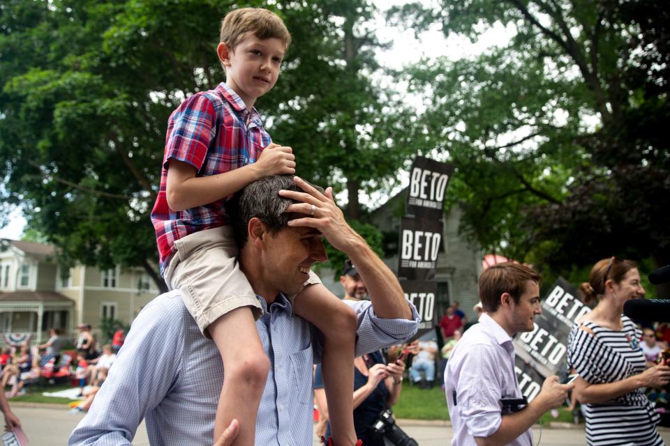 Sen. Beto O'Rourke, D-Texas, walks in the Independence Fourth of July parade with his son Henry, 8, on his shoulders on July 4, 2019, in Independence, Iowa. 