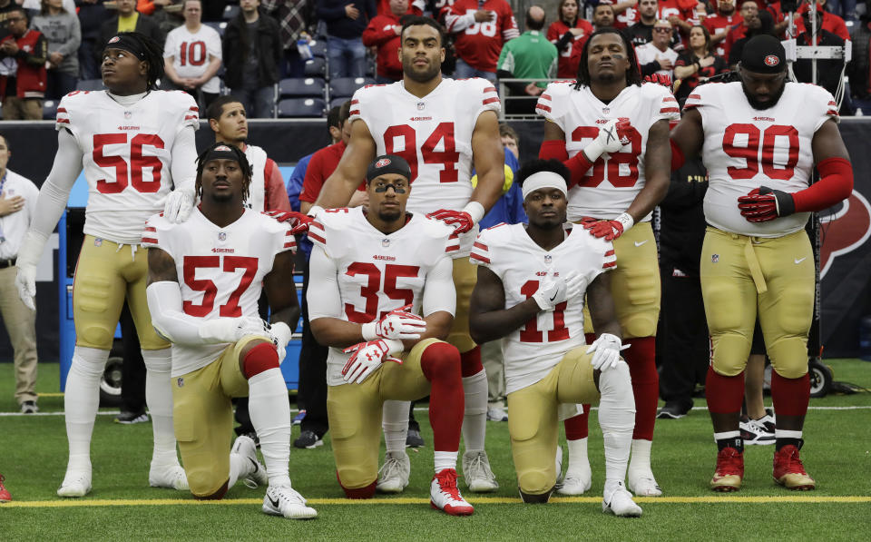 San Francisco 49ers players Eli Harold (57), Eric Reid (35) and Marquise Goodwin (11) kneel during the national anthem before a game against the Houston Texans in Houston on Dec. 10, 2017. (AP/David J. Phillip)