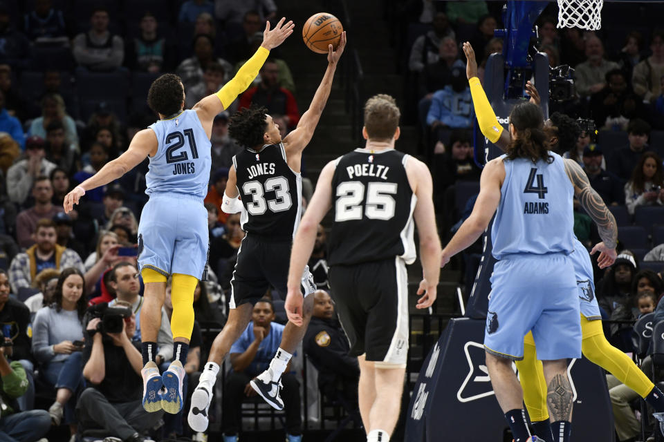 San Antonio Spurs guard Tre Jones (33) shoots ahead of his brother Memphis Grizzlies guard Tyus Jones (21) in the first half of an NBA basketball game, Monday, Jan. 9, 2023, in Memphis, Tenn. (AP Photo/Brandon Dill)