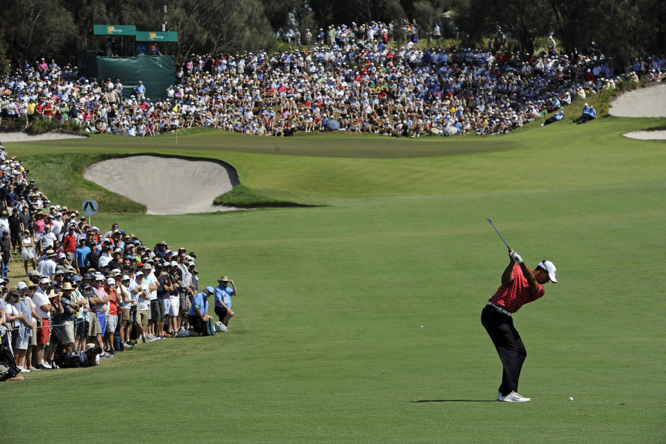 In this Nov. 18, 2011, file photo Tiger Woods hits an approach shot to the fourth hole during the second round of the Presidents Cup golf tournament at Royal Melbourne Golf Course, in Melbourne, Australia. Woods will captain the U.S. team at this year's Presidents Cup as Royal Melbourne golf course will host the Presidents Cup in December for the third time, and is where the International Team won its only previous tournament against the United States in 1998. ( AP Photo/Andrew Brownbill, File)