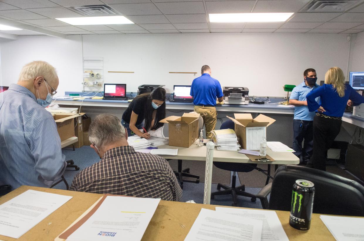 <p>Republican observers watch election officials counting absentee ballots during the Georgia presidential election recount</p> (AP)