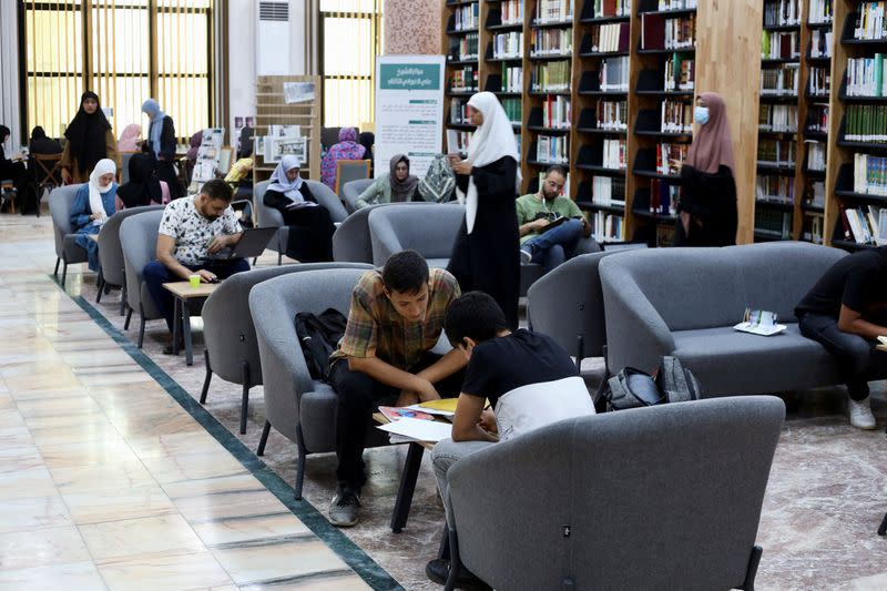 A group of students study for the exams inside a library which provides electricity, in Tajoura district in Tripoli