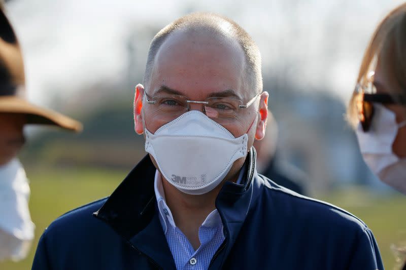 Ukrainian Health Minister Maksym Stepanov stands near a plane as medical personnel depart for coronavirus-hit Italy at an airport in Kiev