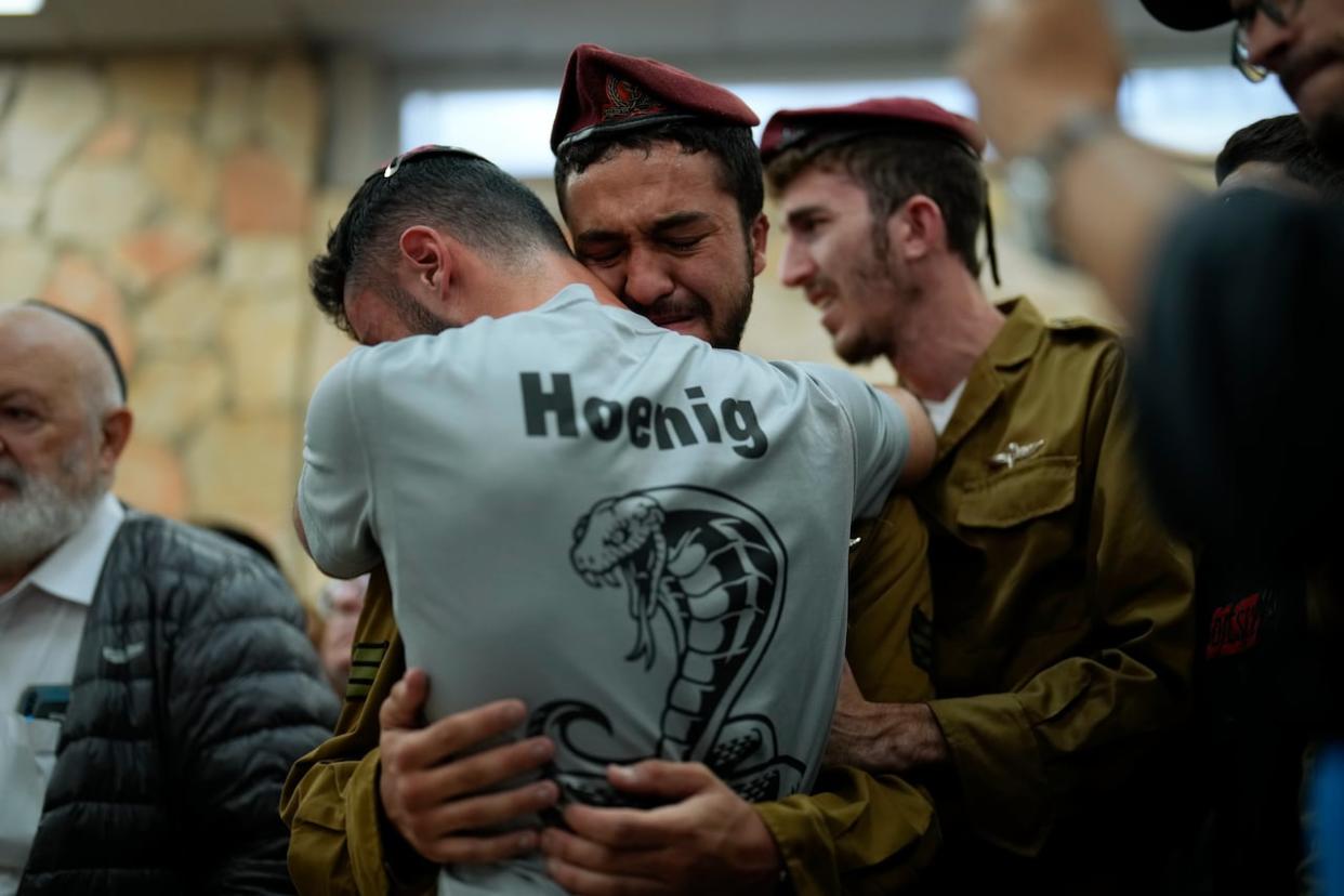 Mourners react during the funeral of Israeli soldier Benjamin Loeb, a dual Israeli-French citizen, in Jerusalem, Tuesday, Oct. 10, 2023. Loeb was killed on Saturday as the militant Hamas rulers of the Gaza Strip carried out an unprecedented, multi-front attack on Israel. (Francisco Seco/AP - image credit)