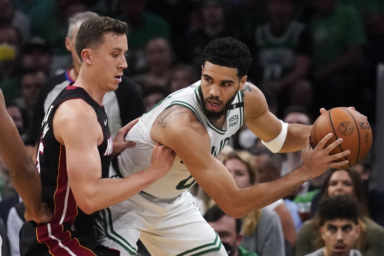 Jayson Tatum (derecha) de los Celtics de Boston ante la marca de Duncan Robinson del Heat de Miami, en las finales de la Conferencia Este de la NBA, el lunes 23 de mayo de 2022. (AP Foto/Charles Krupa)