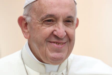 FILE PHOTO: Pope Francis smiles as he arrives to lead the weekly general audience in Saint Peter's Square at the Vatican, October 17, 2018. REUTERS/Tony Gentile