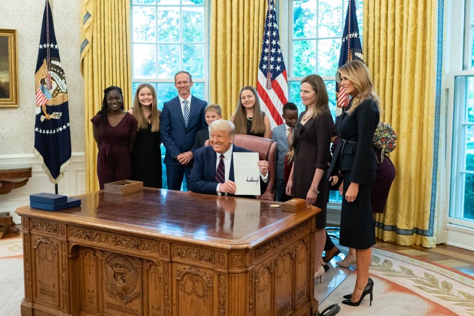 President Donald J. Trump and First Lady Melania Trump pose for a photo with Judge Amy Coney Barrett, the President’s nominee for Associate Justice of the Supreme Court of the United States, her husband Jesse and their children Saturday, Sept. 26, 2020, in the Oval Office of the White House.